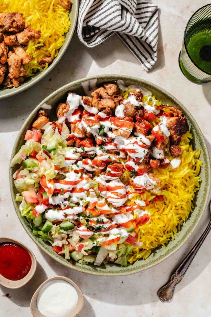 Halal Cart-Style Chicken and Rice plated with white sauce - Halal recipe