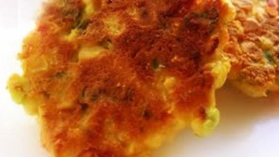 Golden halal Mennonite corn fritters served on a plate with syrup - halal recipe